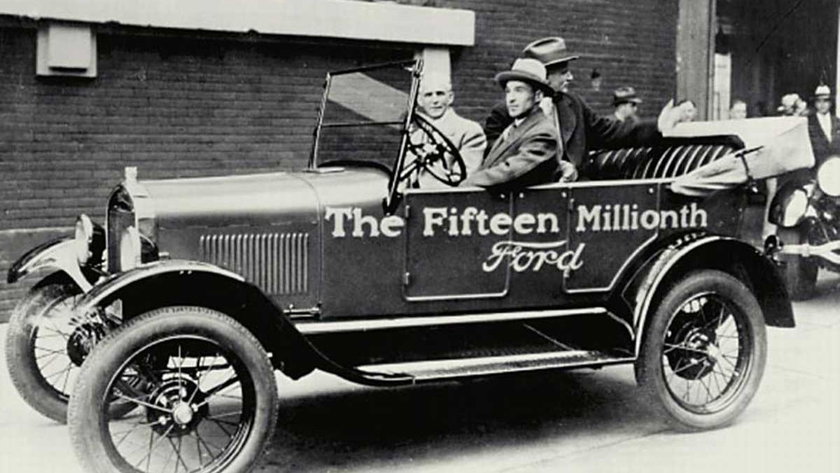Edsel Ford drives his father, Henry, out of the Ford Highland Park Plant in the very last Model T ever made